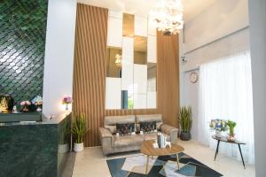 a living room with a couch and a table at MINI Plume Minburi in Min Buri
