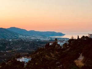 a view of a city from a hill at sunset at Natura Escapade in Torrox