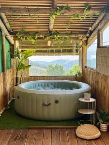 a large bath tub in a room with a window at Refúgio das Carquejas in Mondim de Basto