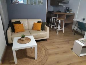 a living room with a couch and a table at studio centre de Gap in Gap