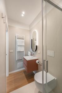 a bathroom with a toilet and a sink at Altrove Boutique Studios in Caserta +47 photos