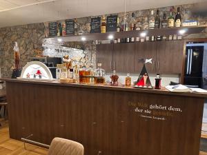 a bar in a restaurant with a counter top at Pension und Berggasthaus Am Knochen in Geyer