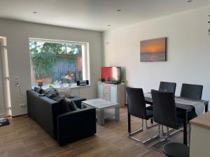 a living room with a couch and a table at Ferienhaus Calle in Bücken