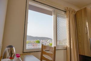 a large window with a view of a city at The RRA Kabras Hotel, Nathdwara in Nāthdwāra