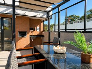 a patio with a table and chairs and a house at Aurea Baulten by 123Quarto in Tambaú