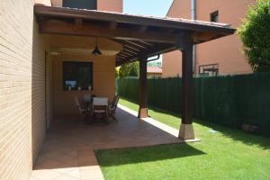 a pavilion with a table and chairs on a patio at Casa Río Tera in Garray