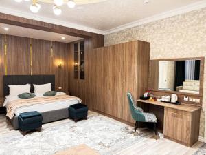 a bedroom with a bed and a desk and a chair at Silk Road Empire in Samarkand +67 photos