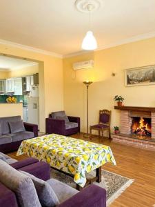 a living room with a couch and a fireplace at Дом для отпуска в Гонио in Gonio