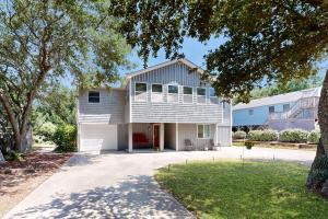 a white house with a gambrel roof at Worries not Found in Kill Devil Hills