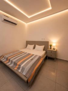 a bedroom with a large bed with a night stand at Djess service in Abidjan
