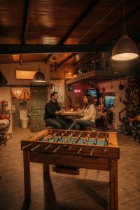 a group of three people sitting in a room with a table at LARCADE Loft Industrial-Jacuzzi in Castillo de Bayuela