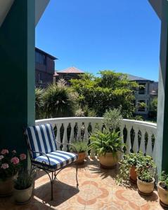 a chair sitting on a balcony with potted plants at Дом для отпуска в Гонио in Gonio +8 photos