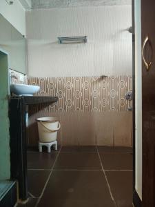 a bathroom with a toilet and a sink at The Alibag Beach hotel- Grantley in Alībāg