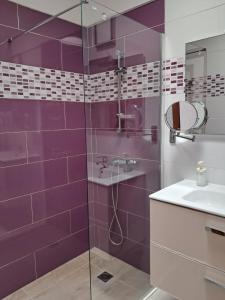 a purple bathroom with a shower and a sink at Apartamentos herederos Lm in Caleta de Sebo +47 photos