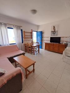 a living room with a couch and a table at Apartamentos herederos Lm in Caleta de Sebo