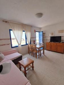 a living room with a couch and a table at Apartamentos herederos Lm in Caleta de Sebo