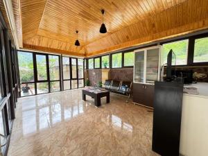 a large living room with a couch and a table at Panoramic Mountains Hotel Guba in Qırızdǝhnǝ