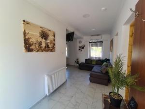 a living room with a couch and a table at Vén Malom Apartman in Zalaszentgrót