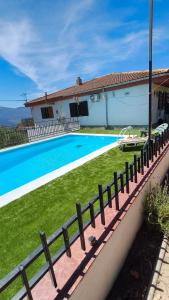 a villa with a swimming pool and a house at Chalet Venta del Aire Cortijo Terrón in Lanjarón