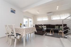 a living room with a couch and a table at Apartment Sankovic in Ražanac
