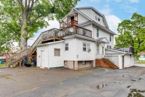 a white house with a balcony on top of it at Train to Philly! Pet-Friendly Unit in Barrington in Barrington
