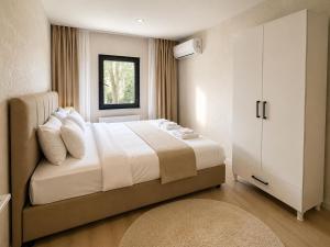 a bedroom with a large bed and a window at Casa Florya Suites in Istanbul +70 photos