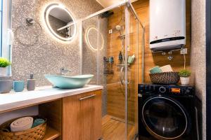 a bathroom with a sink and a washing machine at Modern Harmony in Kolašin +63 photos