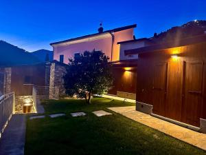 a backyard of a house with a tree in the yard at Agriturismo Terra Madre in Rapallo +21 photos