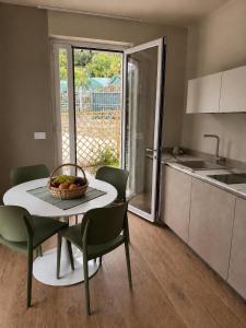 a kitchen with a table with a bowl of fruit on it at Agriturismo Terra Madre in Rapallo