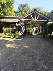 a patio with awning in front of a house at Hazyview Country Cottages in Hazyview