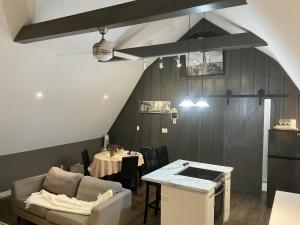 a living room with a table and a couch at Granary Guest House in Goderich +10 photos