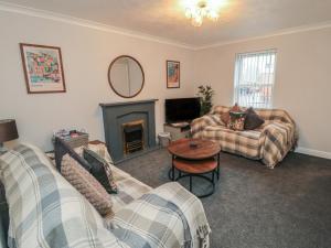 a living room with two couches and a fireplace at 3 Railway Terrace in Bridlington