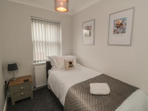 a small bedroom with a bed and a window at 3 Railway Terrace in Bridlington