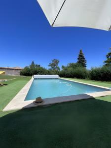 an image of a swimming pool in a yard at Les Chambres du Clos De L'église in Senozan
