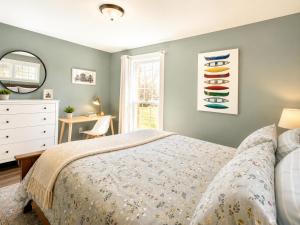 a bedroom with a bed and a dresser and a window at Downtown Picton Retreat - Near Sandbanks and Wineries in Picton