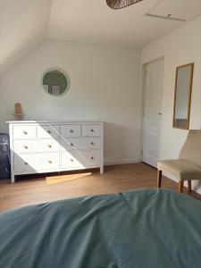 a bedroom with a white dresser and a mirror at La Bohème d'Opale in Boulogne-sur-Mer +6 photos