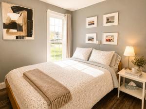 a bedroom with a bed and a window at Downtown Picton Retreat - Near Sandbanks and Wineries in Picton +15 photos
