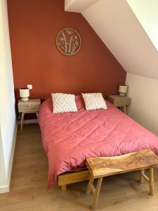a bedroom with a large bed with a red comforter at La Bohème d'Opale in Boulogne-sur-Mer