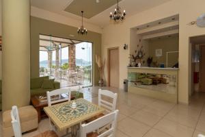 a dining room and living room with a table and chairs at Finiki Plaza in Methoni