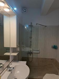 a bathroom with a toilet and a sink and a shower at holidays Nea Peramo in Nea Peramos +7 photos
