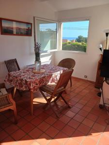 a dining room with a table and chairs at La Villa des Restanques in Carry-le-Rouet