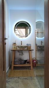 a bathroom with a sink and a mirror at Azad A-Frame in Şotrile