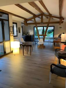 a room with tables and chairs and windows at Les Chambres du Clos De L'église in Senozan
