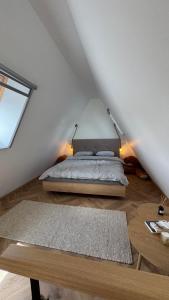 a bedroom with a bed and a table at Azad A-Frame in Şotrile