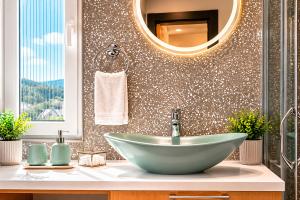 a bathroom with a bowl sink and a mirror at Modern Harmony in Kolašin
