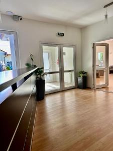 an empty room with a counter and some plants at Las i Morze - Dźwirzyno in Dźwirzyno