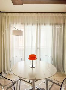 a white table and chairs with a red seat at Jian Stay Bora in Sin'gal +19 photos