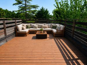 a patio with a couch and a table on a deck at Le Chêne Vert - Grande Villa familiale avec piscine - Bassin d'Arcachon in Arès +24 photos