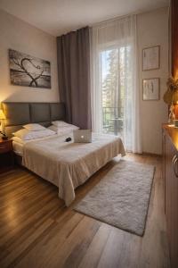 a bedroom with a bed with a laptop on it at Morska Fala in Pobierowo