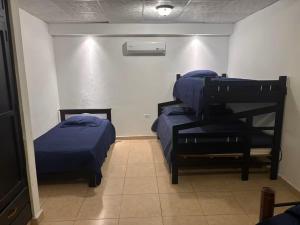a room with two beds in a room at Chitre Villa by Otium in Monagrillo